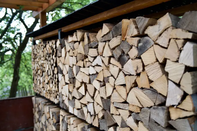 Ocelová dřevníková stěna naskládaná dřevem